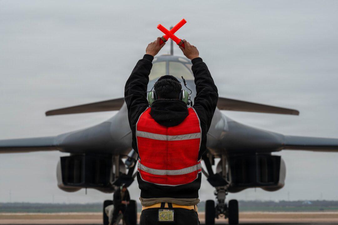 Ground crew marshalling a bomber on the RAF Fairford ramp